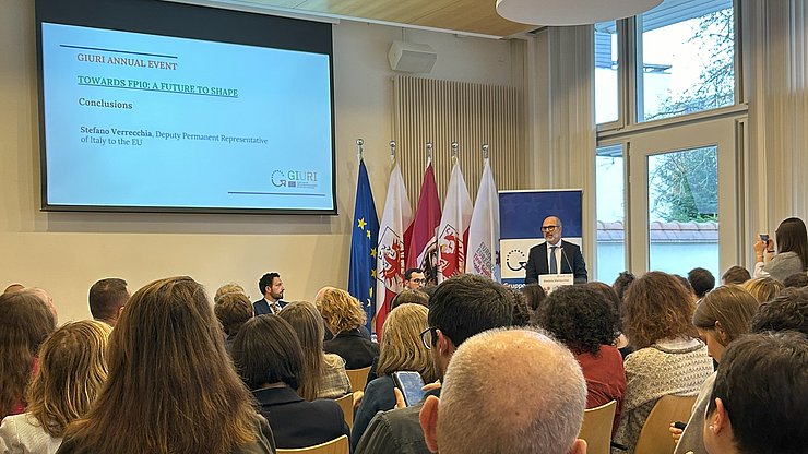 Al podio, l'Ambasciatore Stefano Verrecchia parla alla platea.