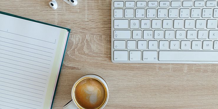 Desk with keyboard and coffee